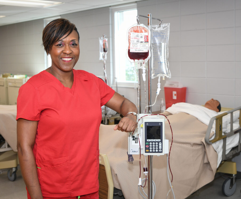 Nursing student, Keya Tabb, posing with nursing tools