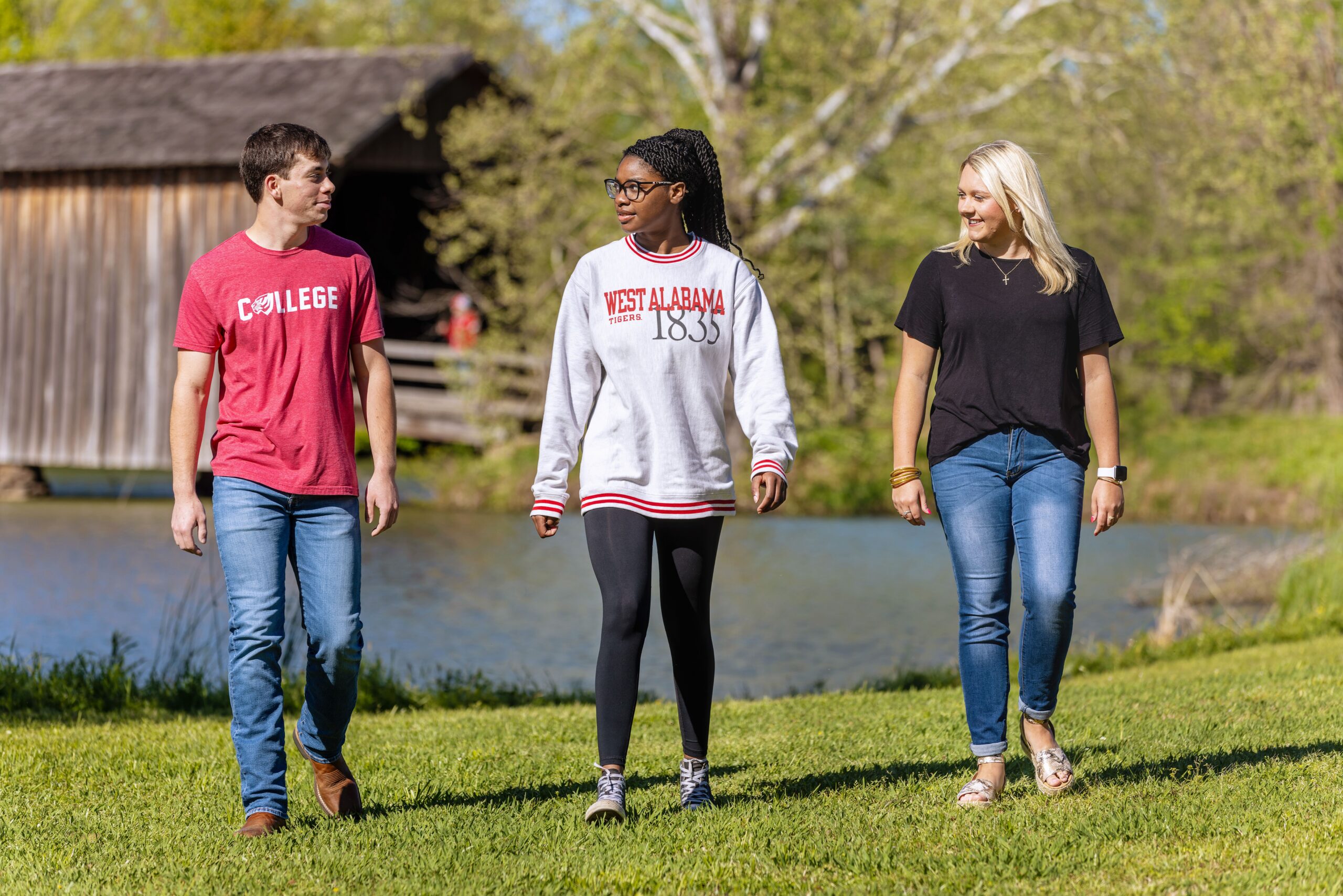 Three students enjoying a walk by the Campus Duck Pond