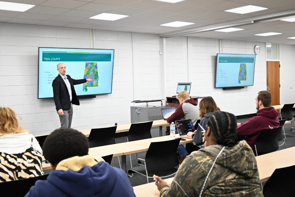 Dr. Jacob Snyder stands in front of a classroom