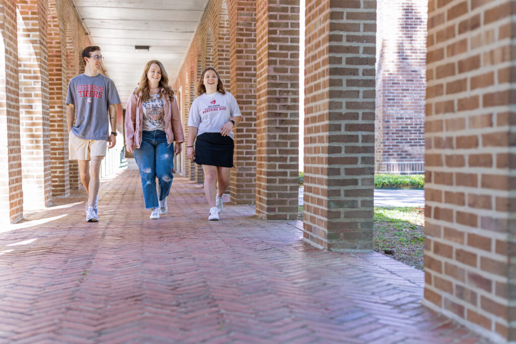 Three UWA students walking between buildings